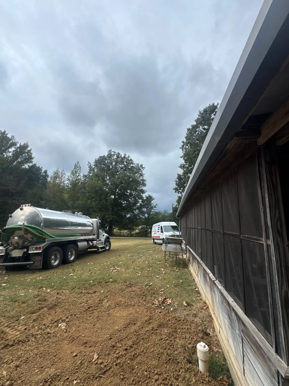 Central Pumping Services vacuum truck positioned beside a commercial building